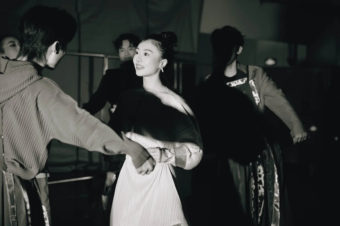 Reincarnated as a Convenience Store: black-and-white photograph of performers in rehearsal